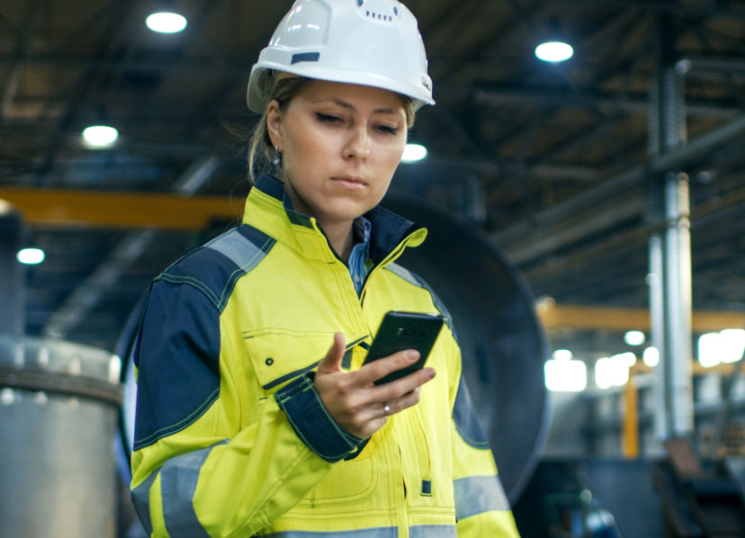 Construction worker looking at her phone - UTFCU